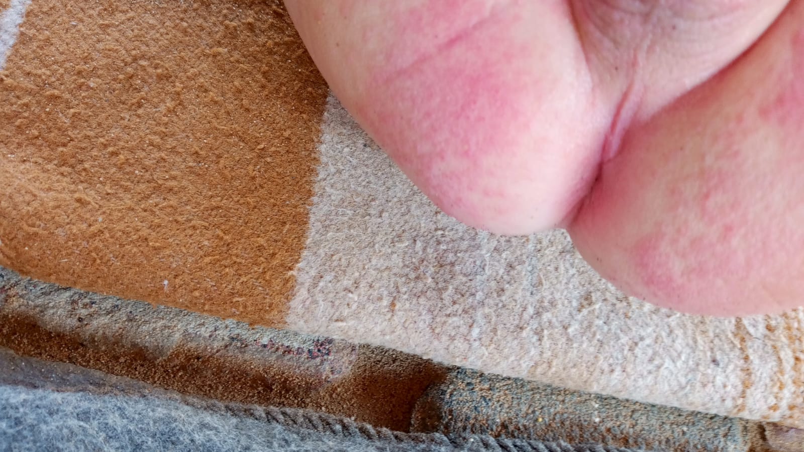 Close-up of fingers against a fabric surface